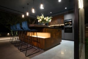 Copper kitchen island with buster and punch pendant lighting