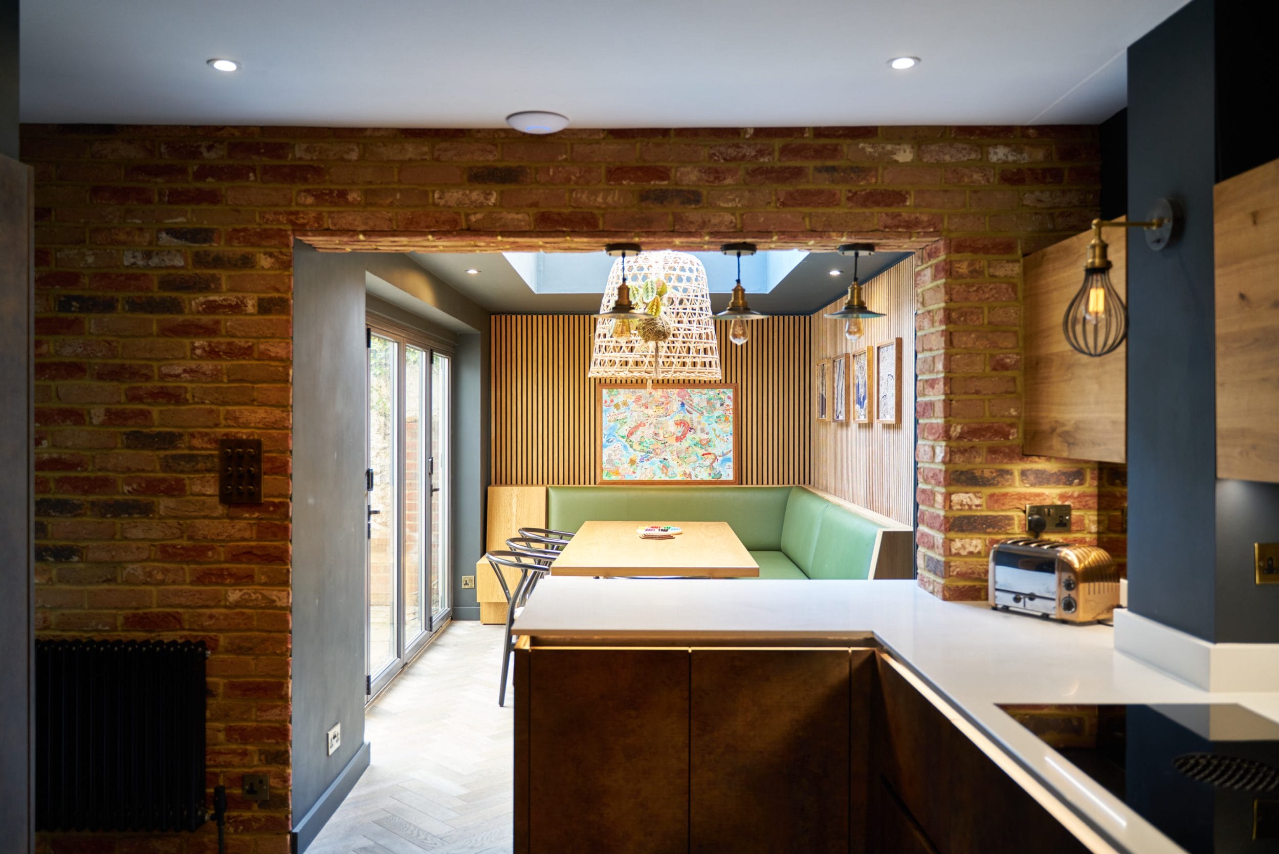 small kitchen with breakfast bar and oak acoustic panelling in brighton, east sussex